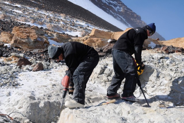 two scientists dig for fossils on mt. kirkpatrick in antarctica