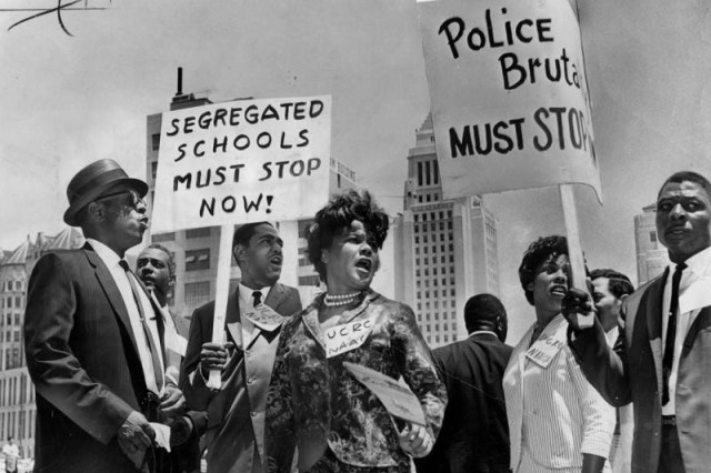 Black and white photo of protesters holding signs