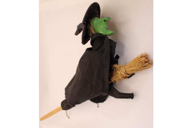 hand made doll of a witch on a broomstick