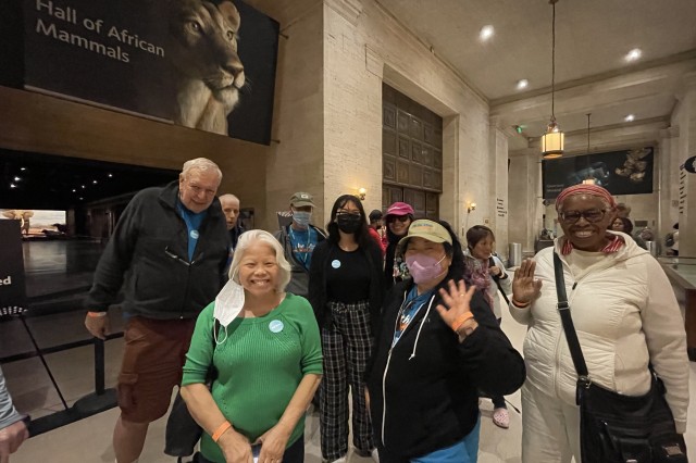 people at museum wave to camera