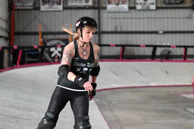 Evil E in her Derby Doll uniform skating on a banked track