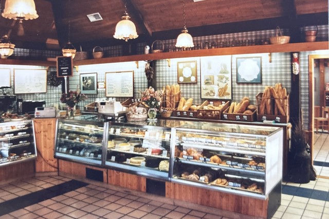 Display counter inside a bakery, filled with fresh baked loafs and cakes