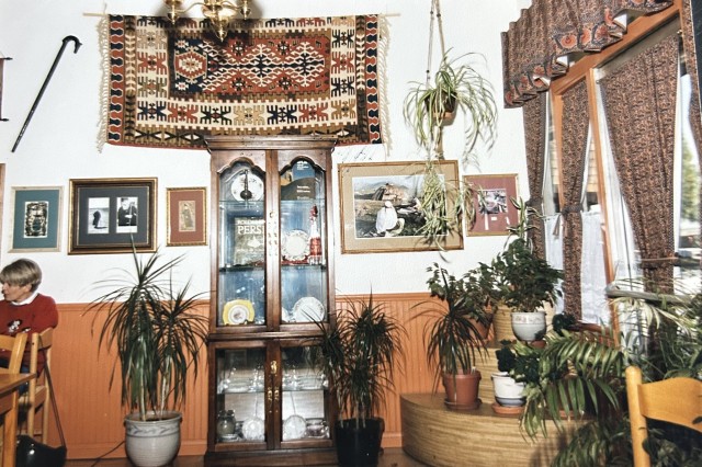 Interior decorations inside an Iranian family bakery with tapestries and family photos on the walls.