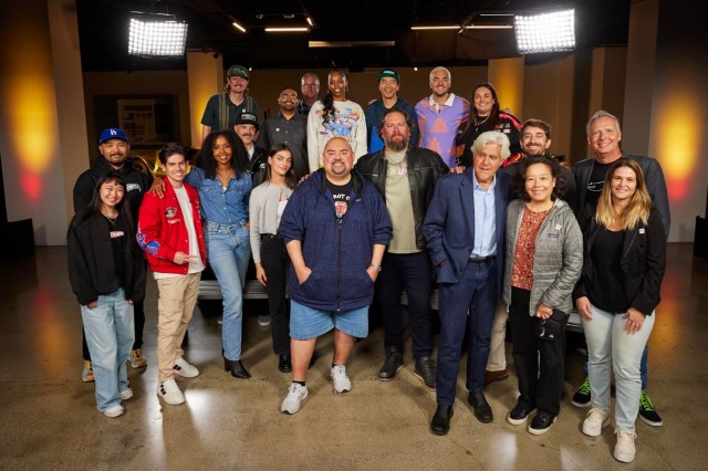 a group of 20 folks pose for a picture at the finale of the 2024 Hot Wheels Legends Tour