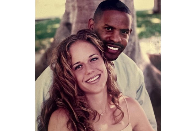 Young man and woman in a couple's photo show under a tree.
