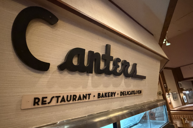 Retro metal bread counter at a deli with the name "Canters" written above.
