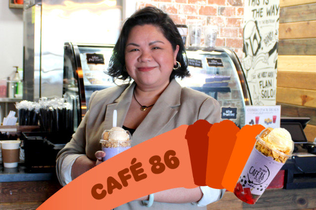 Cafe owner standing in front of a counter holding a colorful iced drink.