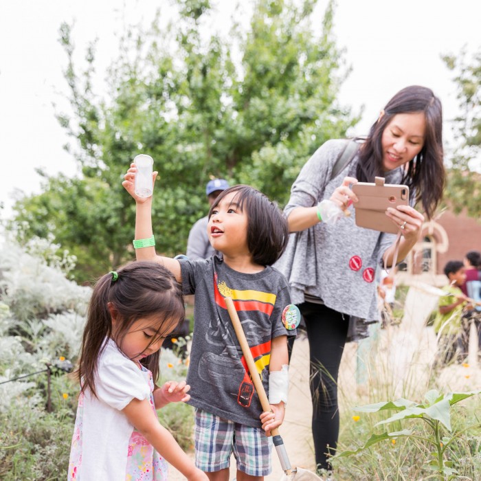 family in the nature gardens at bug fair mother children kids