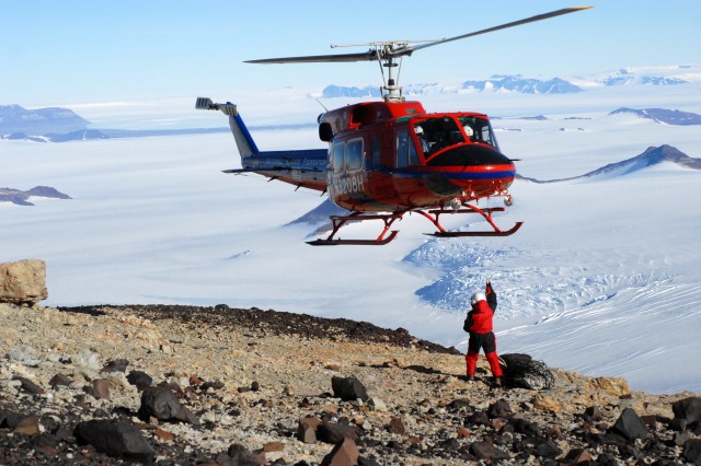 helicopter flying over person in antarctica