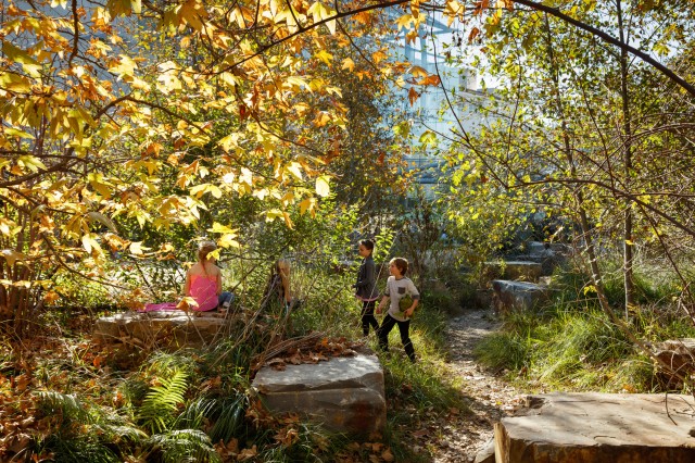 kids in the dry creek bed in the nature gardens