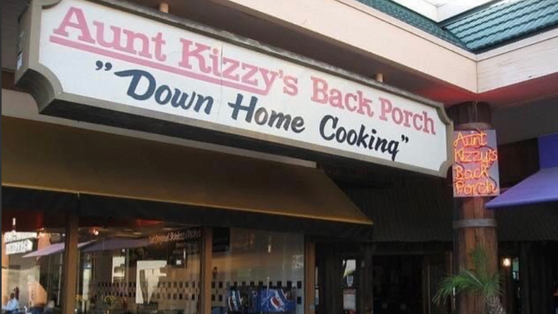Restaurant sign reading &quot;Aunt Kizzy’s Back Porch Down Home Cooking&quot;