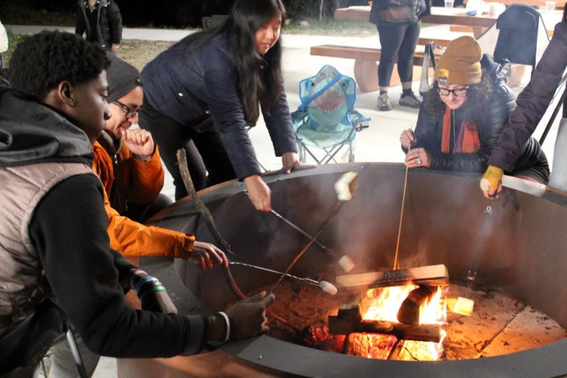 People making smores around campfire 